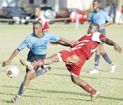 MUCURAPO defender Obed James (right) tries to block the path of QRC forward Akil Morris as he heads to goal during their BGTT SSFL North Zone battle yesterday at the QRCGround, St Clair. ...Author: AZLAN MOHAMMED